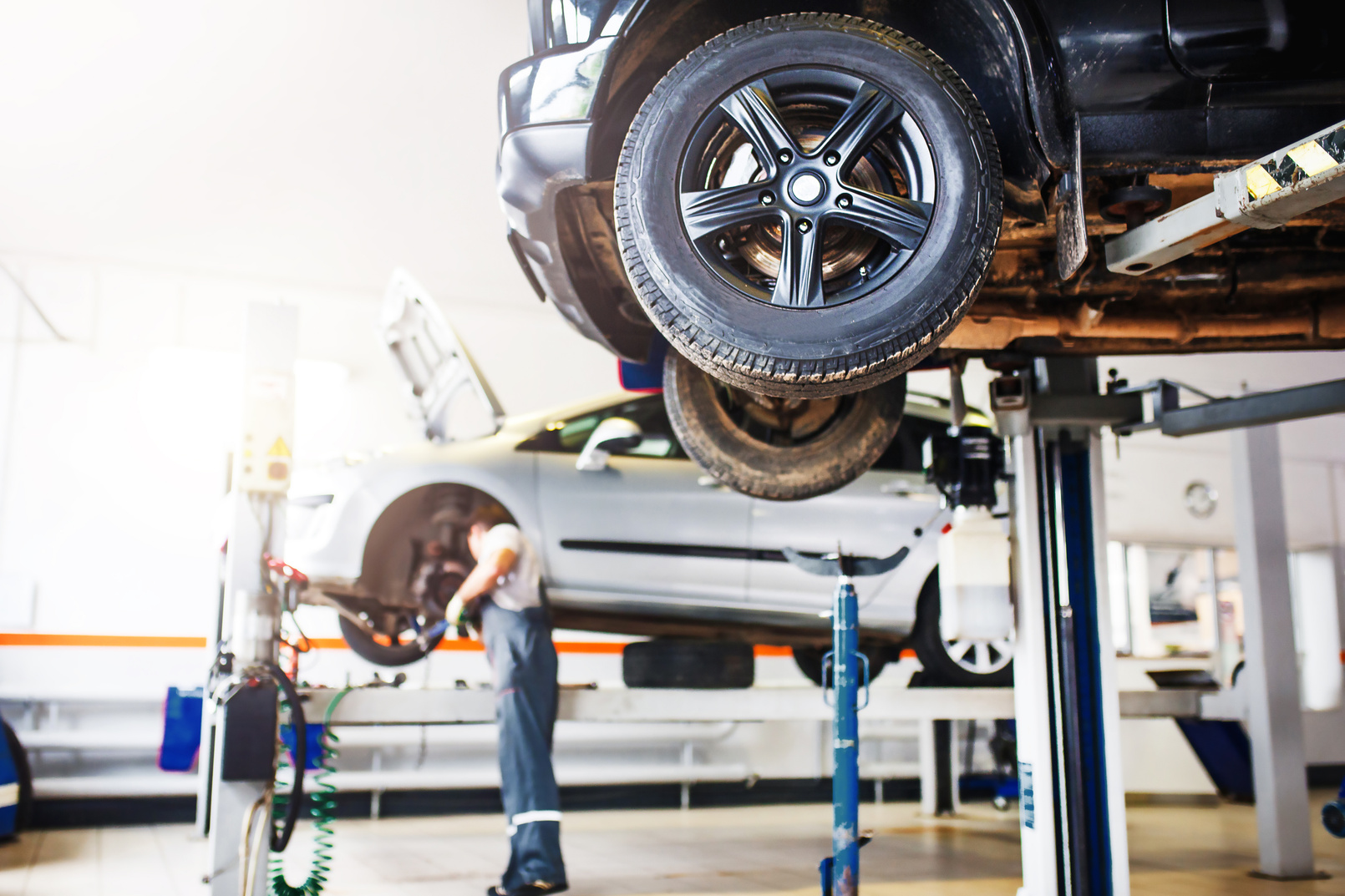 The Car Is Lifted for Repair on a Lift in a Car Service Station,